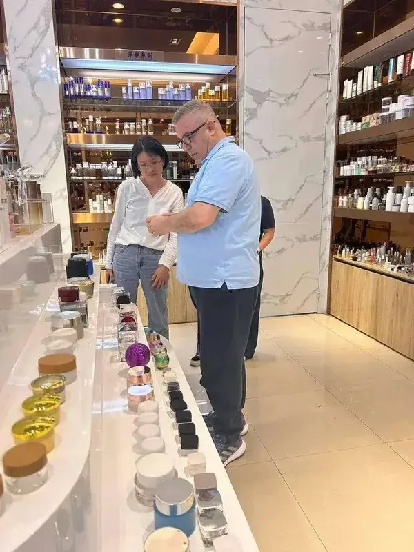 Anis and Nancy inspecting products at a supplier showroom